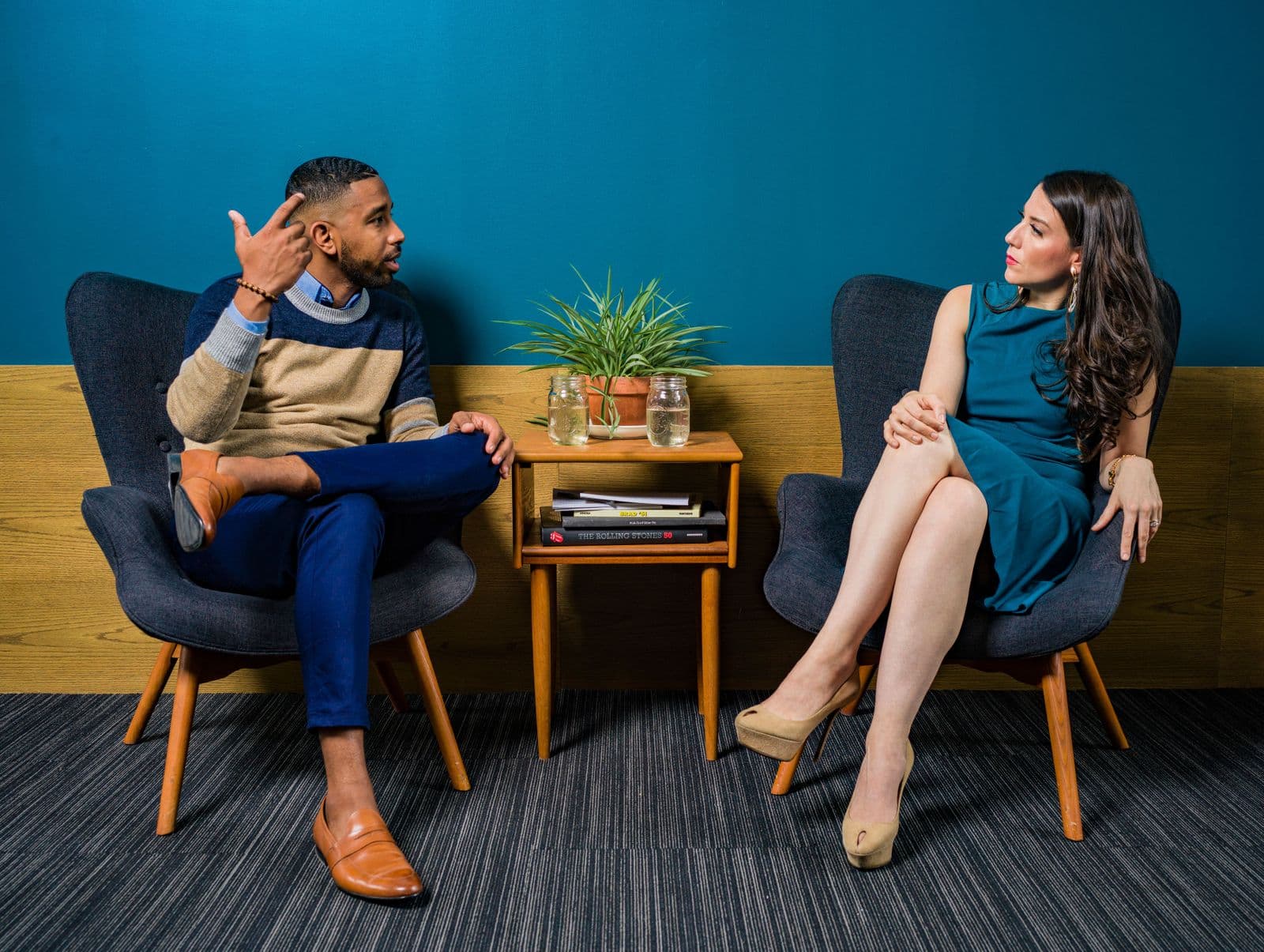 Two people talking in a front room