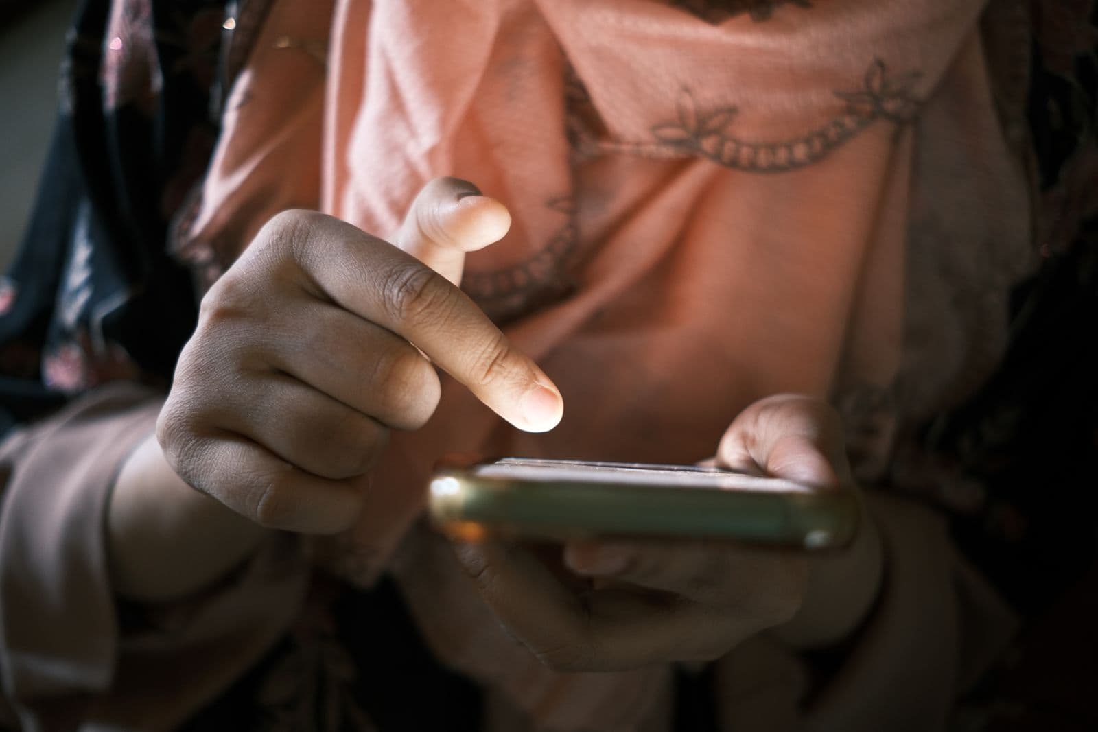 A person holding a phone in both hands